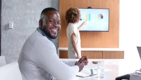 Happy-african-american-casual-businessman-at-office-meeting-with-diverse-colleagues,-slow-motion