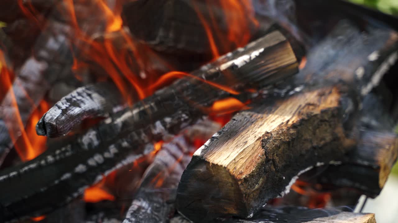 Close up of fire and flames. Warm fireplace with lots of trees ready for barbecue