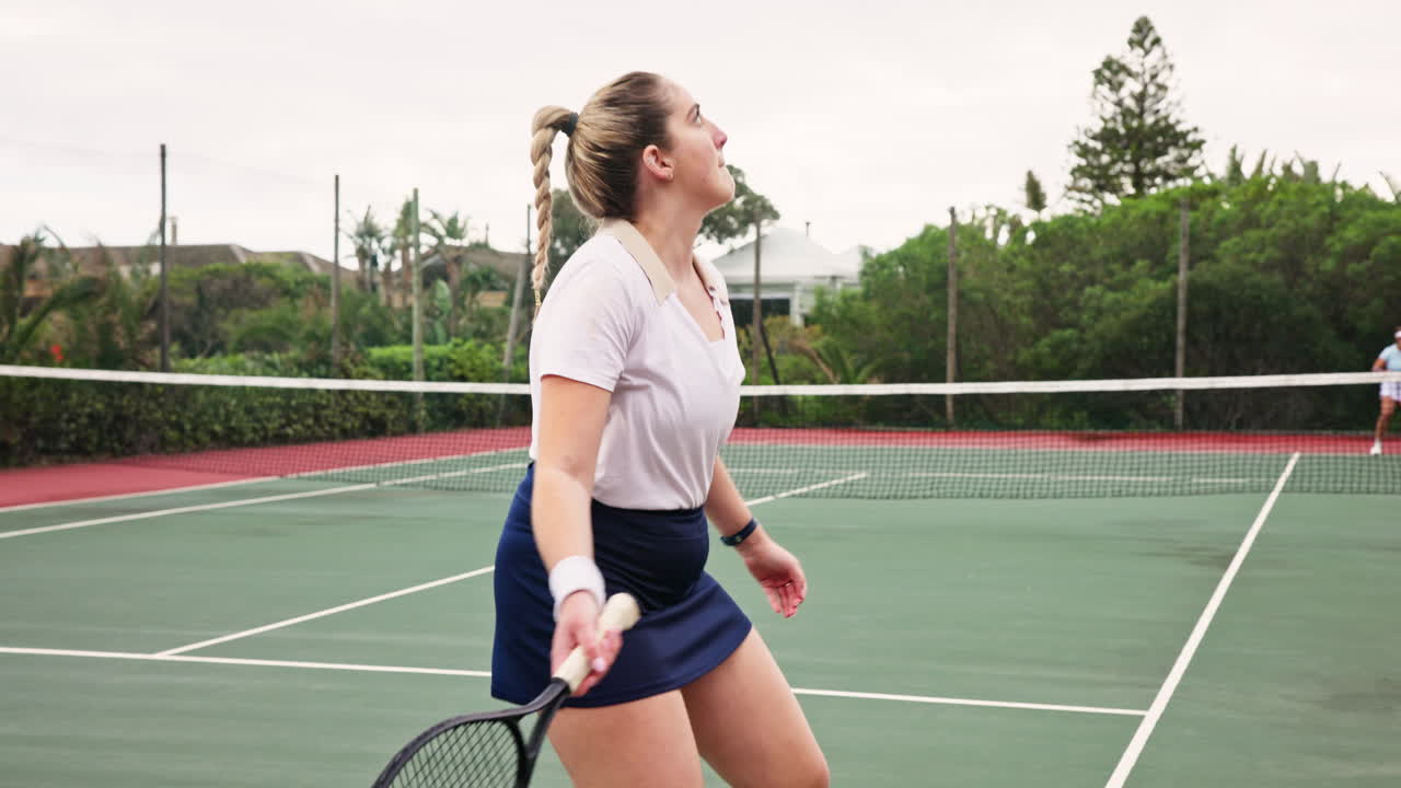 Women playing tennis on a court