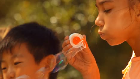 close-up of schoolkids playing with bubble wand