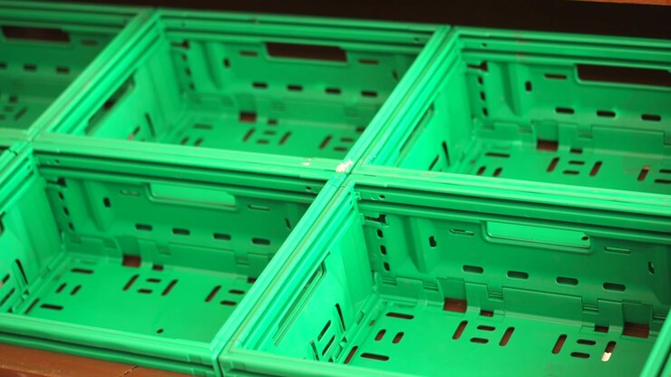 Empty Green Plastic Crates Arranged on a Shelf