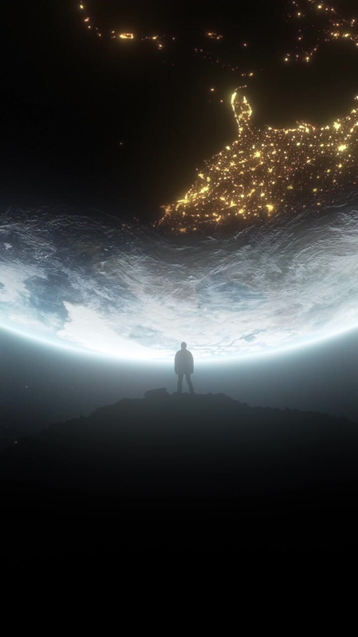 Vertical Video of Silhouetted Male Figure Stood Looking Up at Planet Earth Rotating in Space with City Lights Fading as Daylight Arrives. Concepts of discovery, astronomy, space exploration.