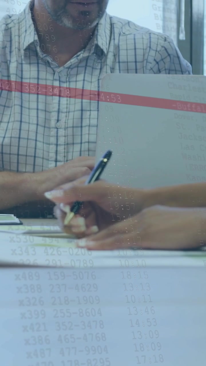 Vertical video: Man watching hands entering, signing docs with pen, red line over laptop for biz