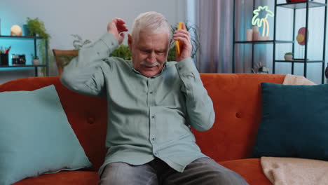 sad grandfather man use smartphone surprised by bad news fortune loss fail lottery results deadline