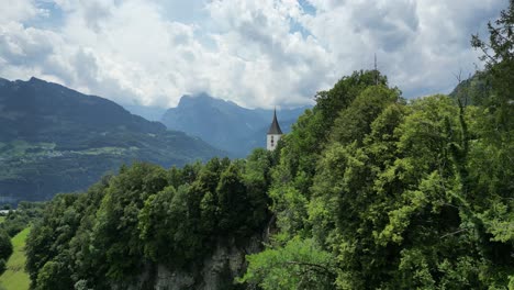 Aerial-view-of-church-spire-in-Amden-amidst-beautiful-Switzerland-landscape