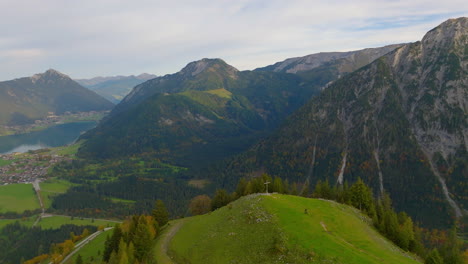 Aerial-view-orbiting-Pertisau-woodland-valley-in-Karwendel-alpine-park-with-extreme-Tyrol-Alps
