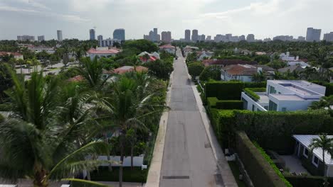 luxury villas and mansion with swimming pool in suburb of west palm beach, florida. downtown with skyline in background. aerial birds eye shot.