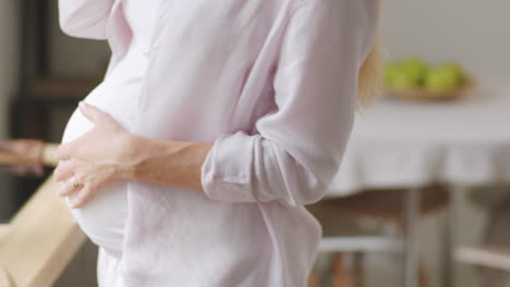 pregnant woman talking on phone at home