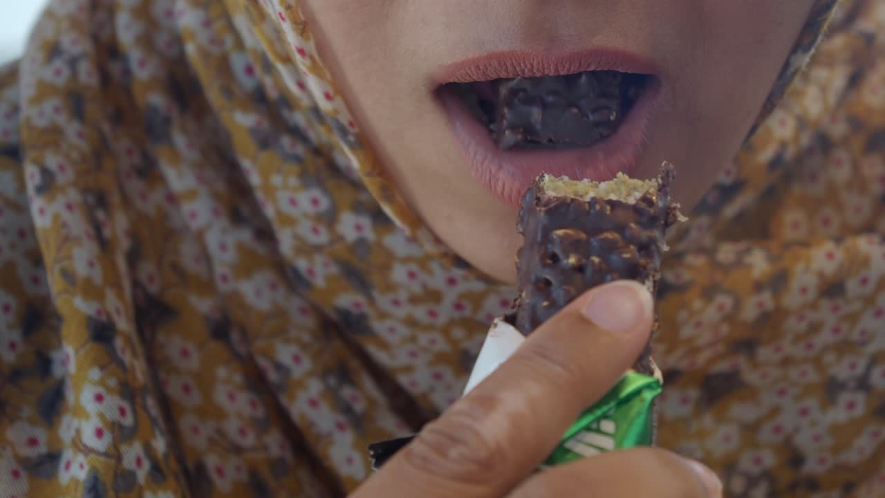 Woman eating a chocolate bar