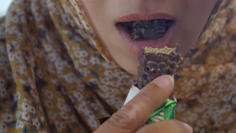 woman eating a chocolate bar