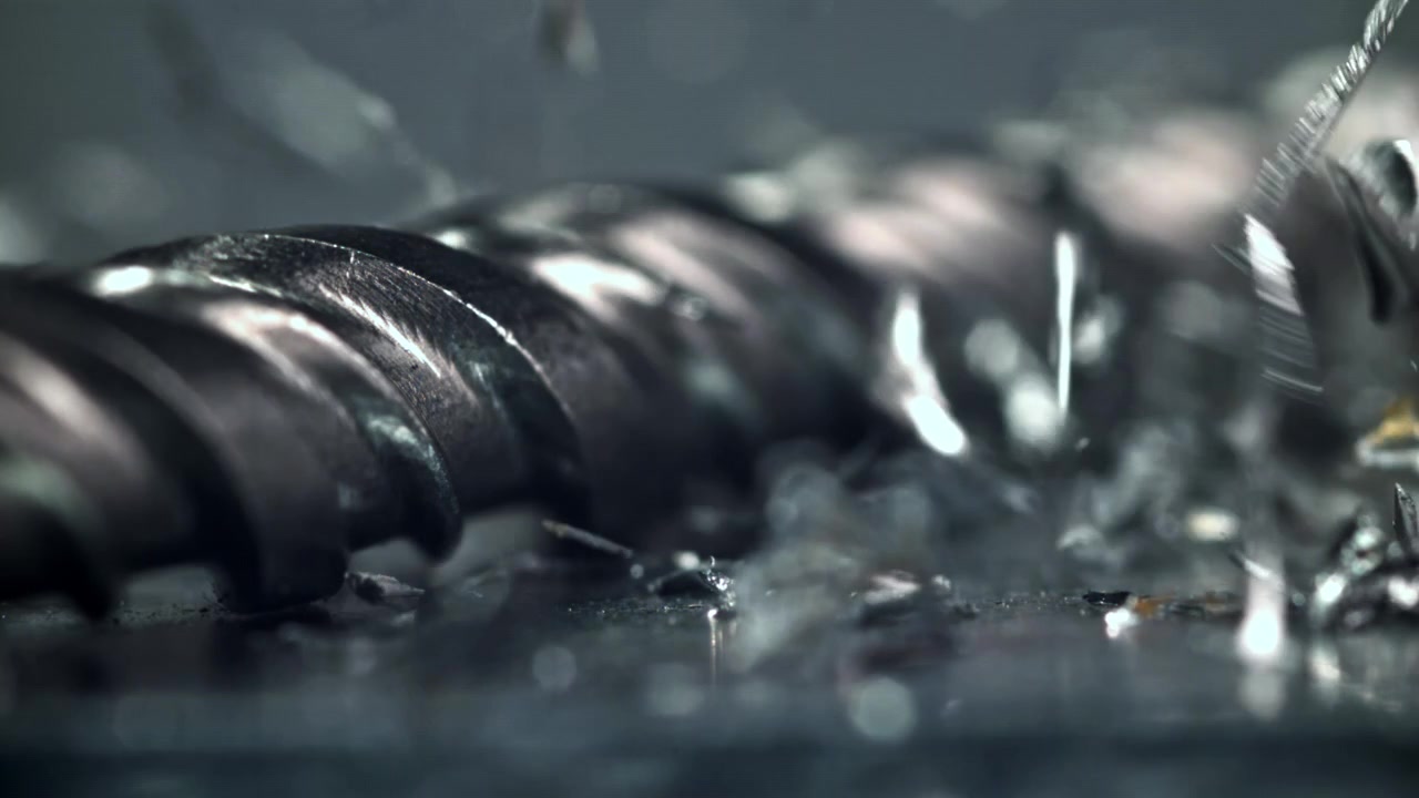 Slow Motion Macro Shot of Metal Shavings Falling on a Drill Bit