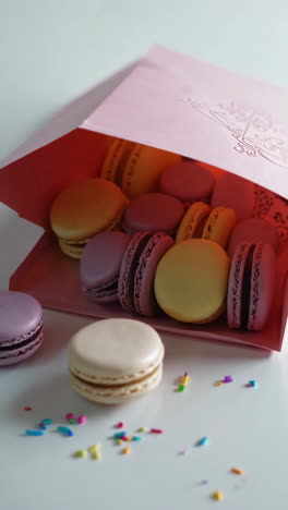 assorted macarons in a pink gift bag