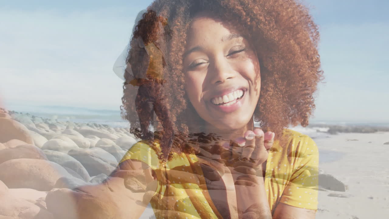 Walking on rocky shore, animation overlay of woman smiling on beach