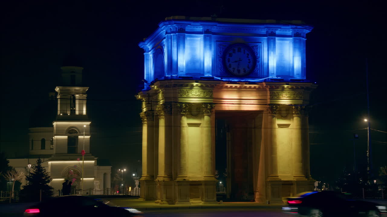 The flag of Ukraine projection on the facade of The Triumphal Arch in the evening