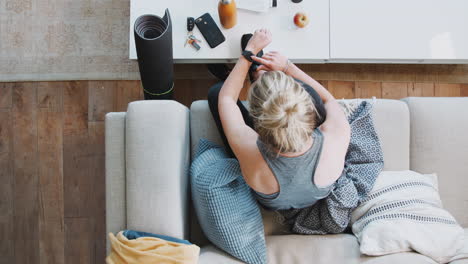 Overhead-Shot-Looking-Down-On-Woman-At-Home-Getting-Ready-To-Go-To-Fitness-Class