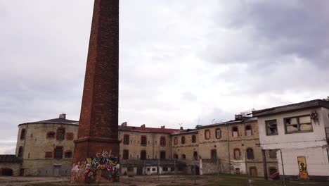 Brick-building-and-chimney-of-Patarei,-abandoned-Soviet-prison-on-the-coast-of-the-Baltic-sea-in-Tallinn