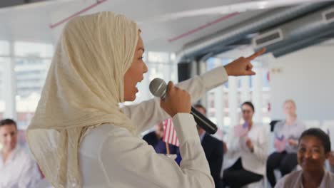 Female-speaker-and-audience-at-political-convention