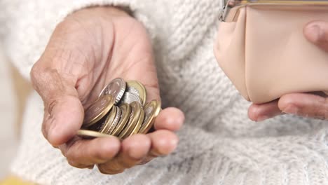 elderly woman holding coins