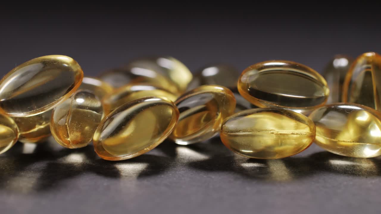Omega fish oil gel capsules on black background close-up . Omega vitamins pills 3 6 9. To be healthy and take care of your health. Pharmaceutical industry. Business of biological supplements and vitamin. High quality 4k footage