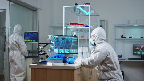 chemist coworkers in ppe suit planning conducting vaccine