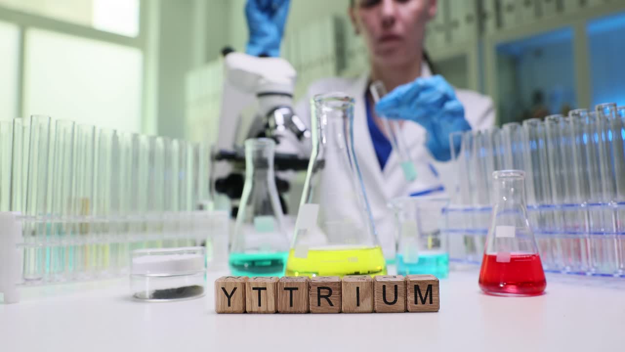 A scientist conducting a chemistry experiment with yttrium in a lab