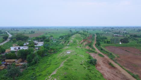 aerial drone view of a rural village of india covered with lush green jungle in gwalior madhya pradesh india