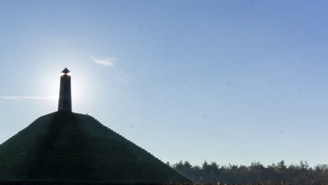 panning Time lapse of sun appearing behind obelisk on Austerlitz Piramid. The Piramide van Austerlitz is a monument built in 1804 as a tribute to Napoleon Bonaparte.