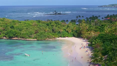 many people at playa la playita beach at las galeras in samana peninsula, dominican republic