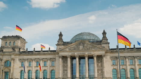 the bundestag building in berlin flags blowing in the wind