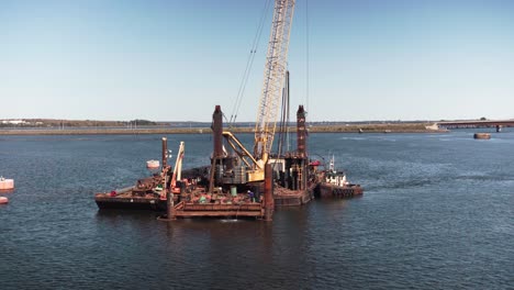 a static shot of workers working at the oilrig for the extraction of oil from the deep sea