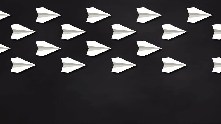 Think differently concept. Red paper plane changes direction. Blackboard Background