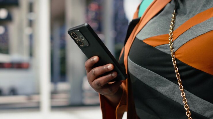 Close up of smartphone used by passenger in bus station to review ticket