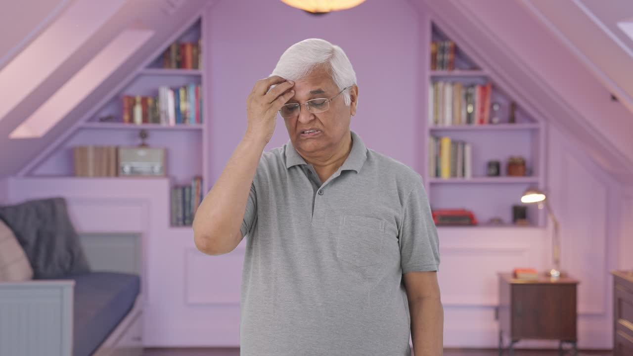 Sick Indian old man having a headache