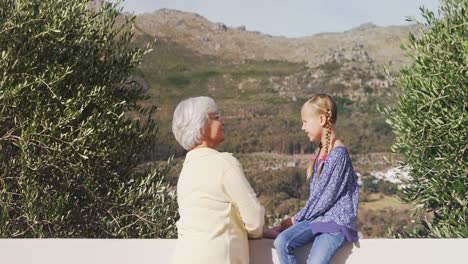 Grandmother-and-little-girl-happily-talking-4K-4k