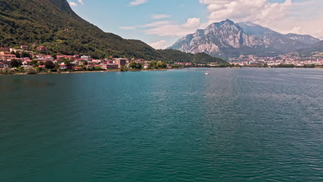 Picturesque-Landscape-On-Lake-Como-With-Peaks-Of-Alps-On-Background-During-Sunny-Day-In-Italy---aerial-drone-shot