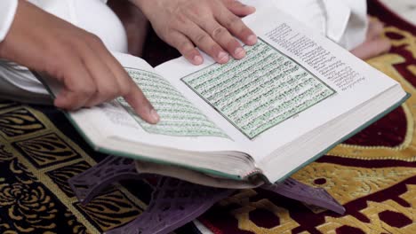 Indian-men-reading-Quran-holy-book-close-up-shot