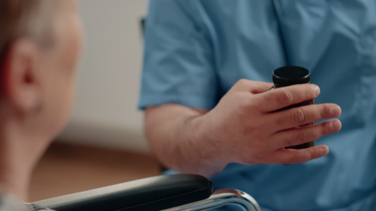 Close up of nurse hand holding bottle of pills and capsules