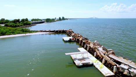 parralax aerial shot of breakwater stone wall protecting harbor and marina from waves