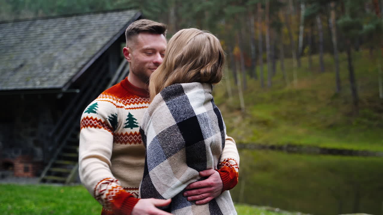 Young couple in love. Romantic couple standing close to each other in warm autumn day. Happy man and beautiful woman having time together outdoors.