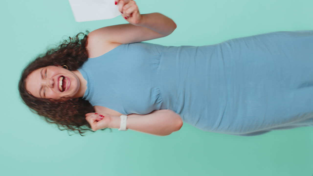 Happy young woman open envelope take out letter reads bank loan approve great news award win
