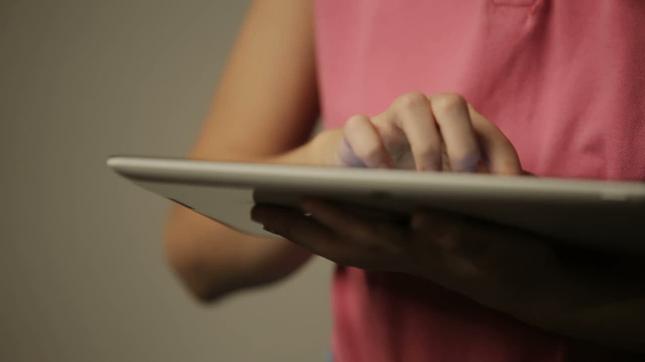 Kid is touching the screen of tablet device