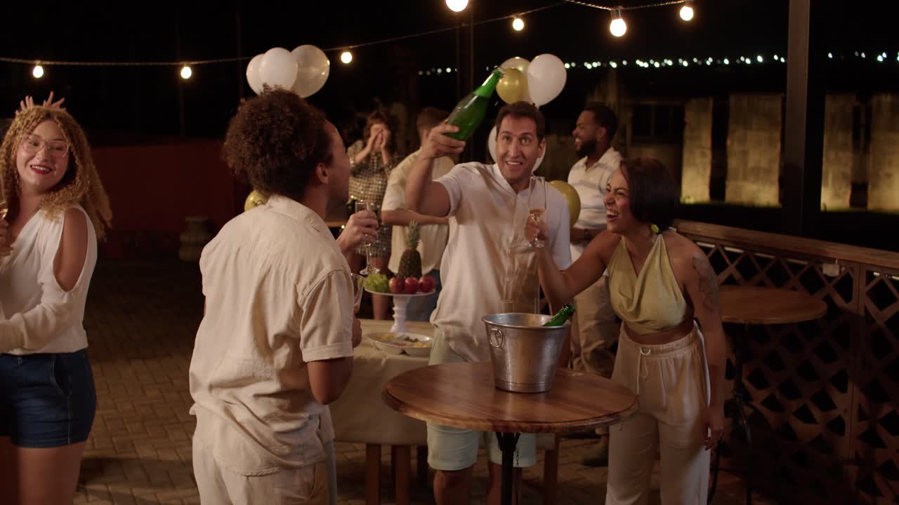 Friends Enjoying a Lively Celebration and Toasting with Champagne at an Outdoor Night Party
