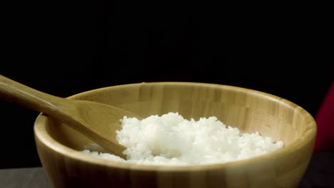 steaming rice in wooden bowl