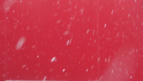 snow falling on a red background