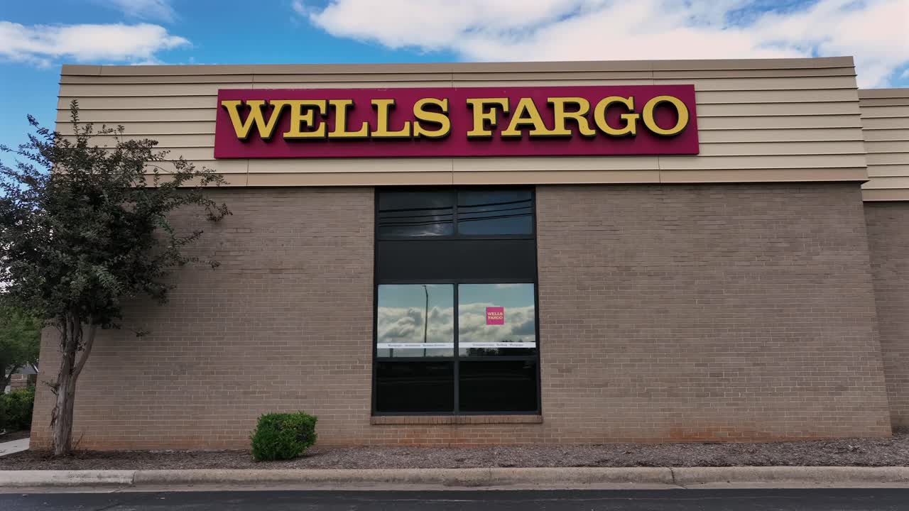 Aerial view of Wells Fargo Bank Building with car reflection in window. American suburb town during sunset time. Close up.