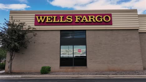 aerial view of wells fargo bank building with car reflection in window. american suburb town during sunset time. close up.