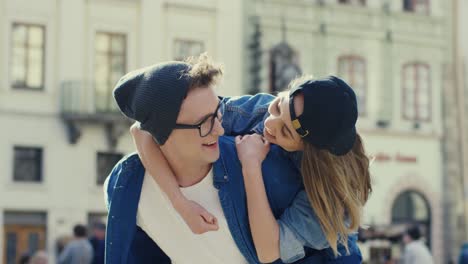 couple of hipsters hugging and having fun while walking