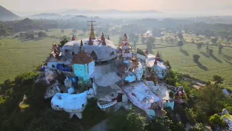 brightly colored temple on top of the hill