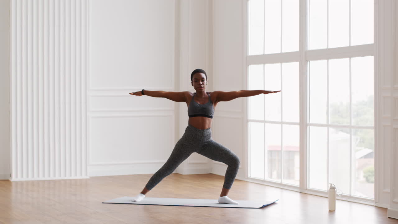 Woman practicing yoga warrior pose
