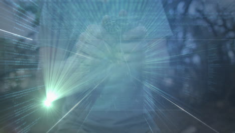 man raising clenched fist over code streams and light beams, merging tech with forest silhouettes